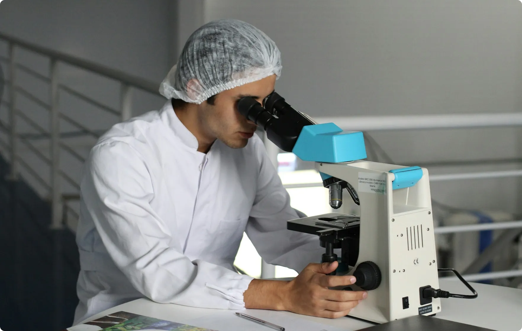 A Person conducting a research through a microscope shown in a blog from Space Inventive
