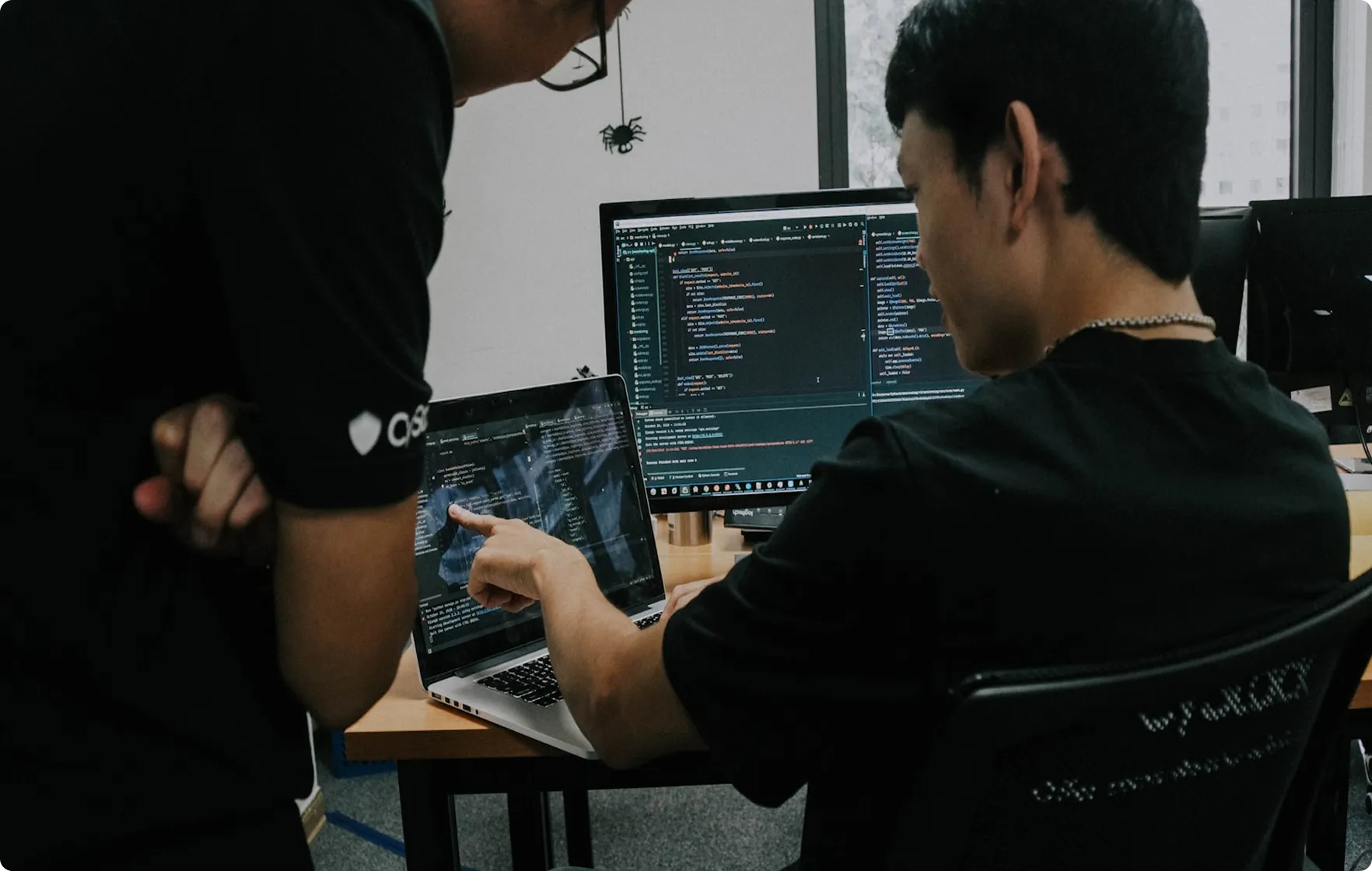 People Discussing on a Development code through a scalable pipeline at Space Inventive.