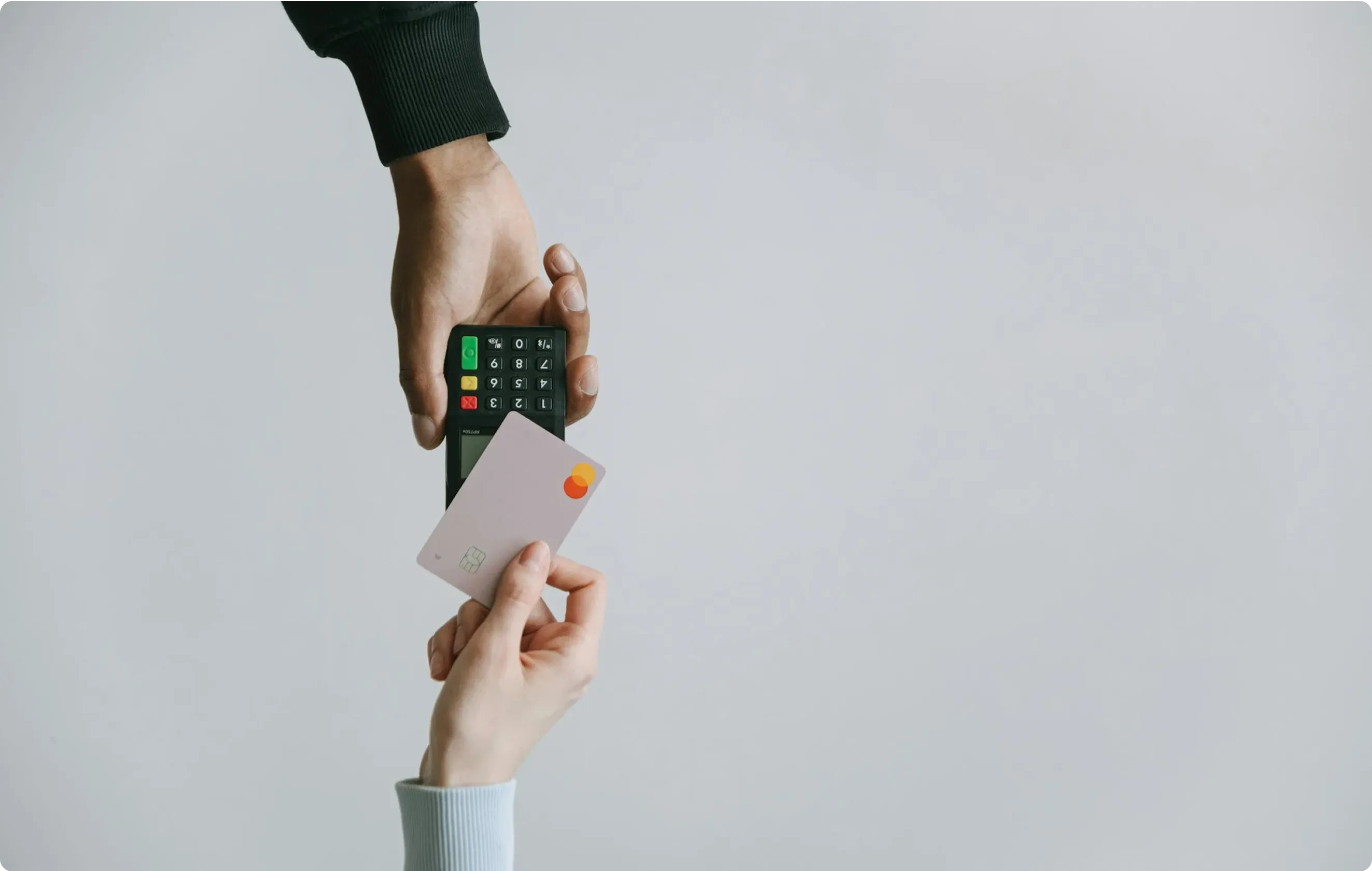 Space Inventive's blog image: Two sets of hands perform a payment transaction with a POS terminal and card, illustrating user experience, efficiency, and the psychology of perceived speed.